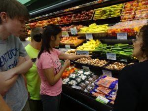 Girl Examining Produce
