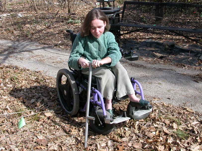 Woman in wheelchair using device to test the soil