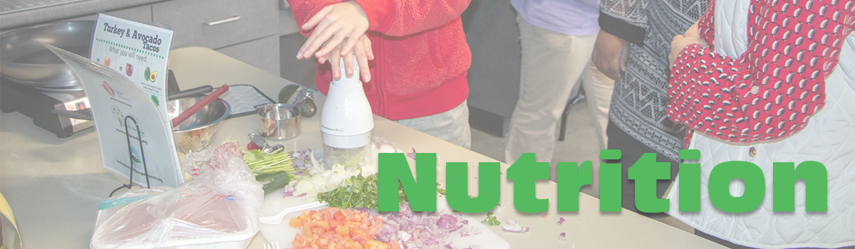 Photo of a person using an adaptive tool called a Slap Chop to cut vegetables.